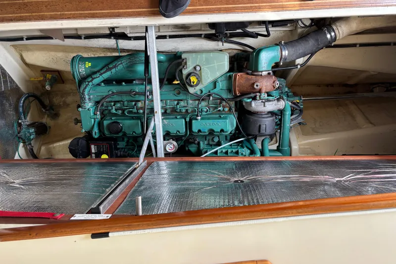 Slide: The Image of 2004 Camano Trawler engine compartment with visible green engine components and insulation. - 25