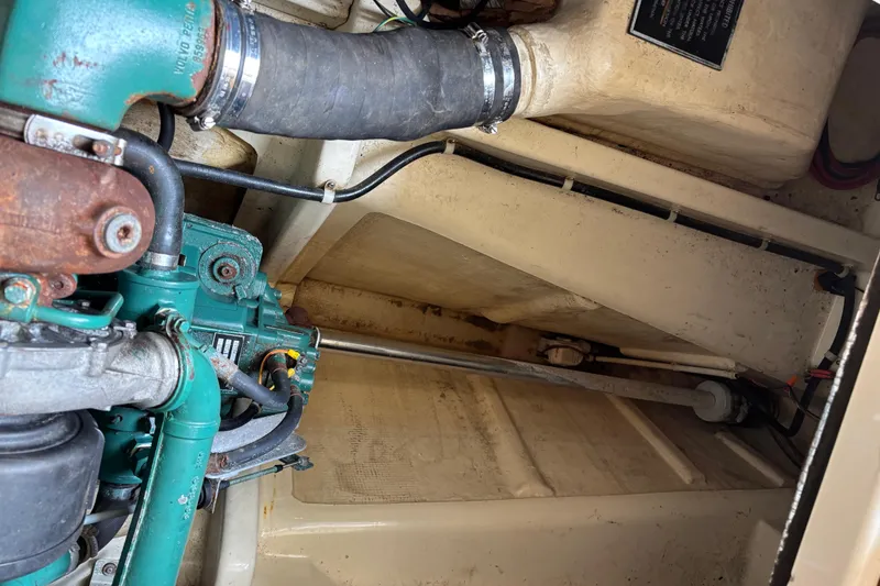 Slide: The Image of Engine compartment of a 2004 Camano Trawler, showcasing mechanical components and piping. - 26