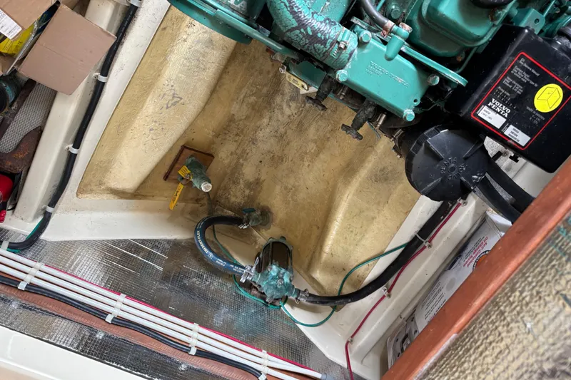 Slide: The Image of Engine compartment of a 2004 Camano Trawler with visible wiring and components. - 27