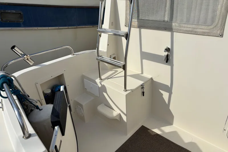 Slide: The Image of 2004 Camano Trawler boat interior with ladder and storage compartments. - 6