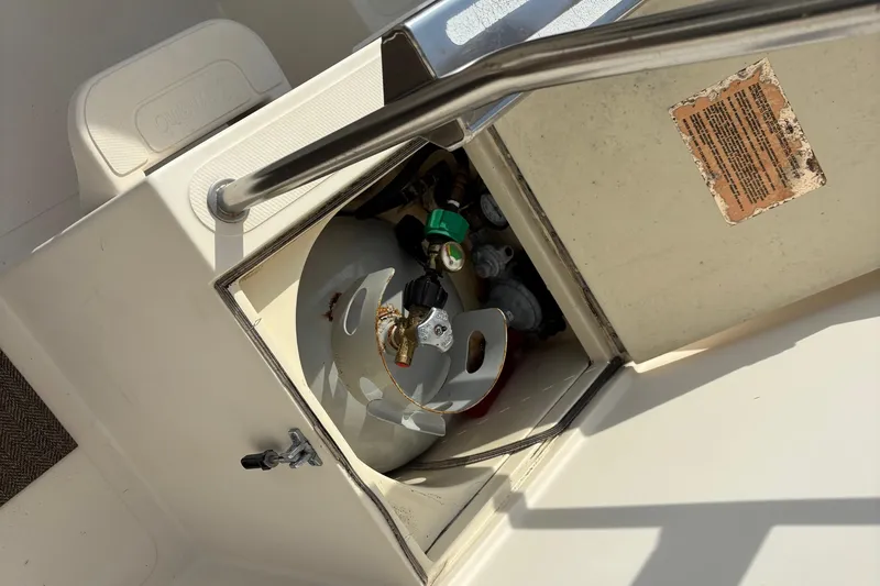 Slide: The Image of 2004 Camano Trawler propane storage compartment with safety instructions. - 7