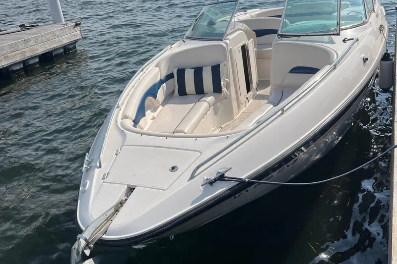 Slide: The Image of Chaparral 2830 SS 1999 boat docked on water, featuring spacious seating and sleek design. - 0