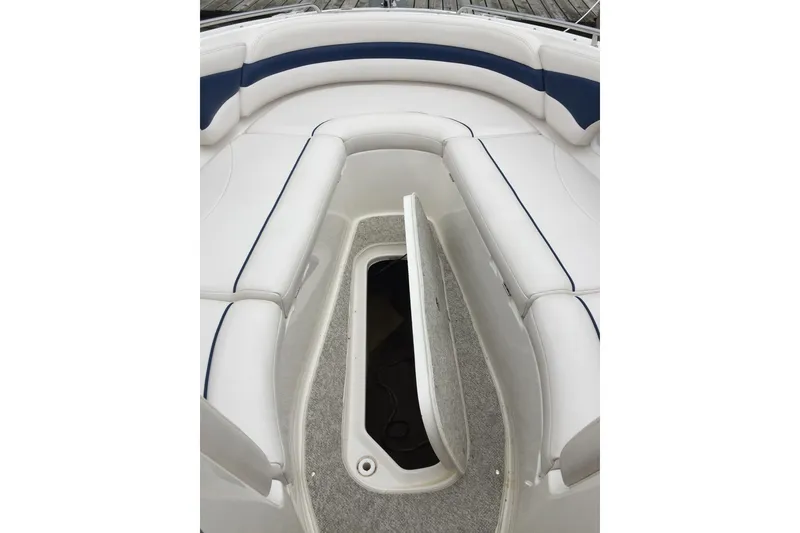 Slide: The Image of 1999 Chaparral 2830 SS boat interior with open storage compartment and cushioned seating. - 10