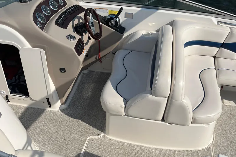 Slide: The Image of 1999 Chaparral 2830 SS boat interior with steering wheel and cushioned seating. - 11