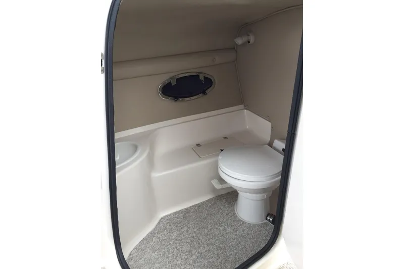 Slide: The Image of 1999 Chaparral 2830 SS boat interior bathroom with toilet and small window. - 12