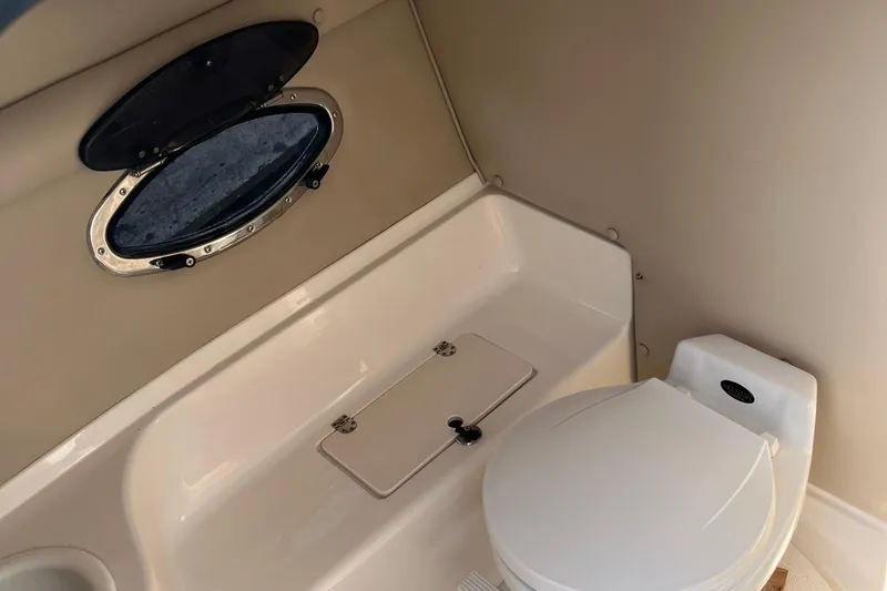 Slide: The Image of 1999 Chaparral 2830 SS boat interior with toilet and porthole window. - 13