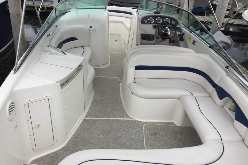 Slide: The Image of 1999 Chaparral 2830 SS boat interior with white seating and dashboard. - 6