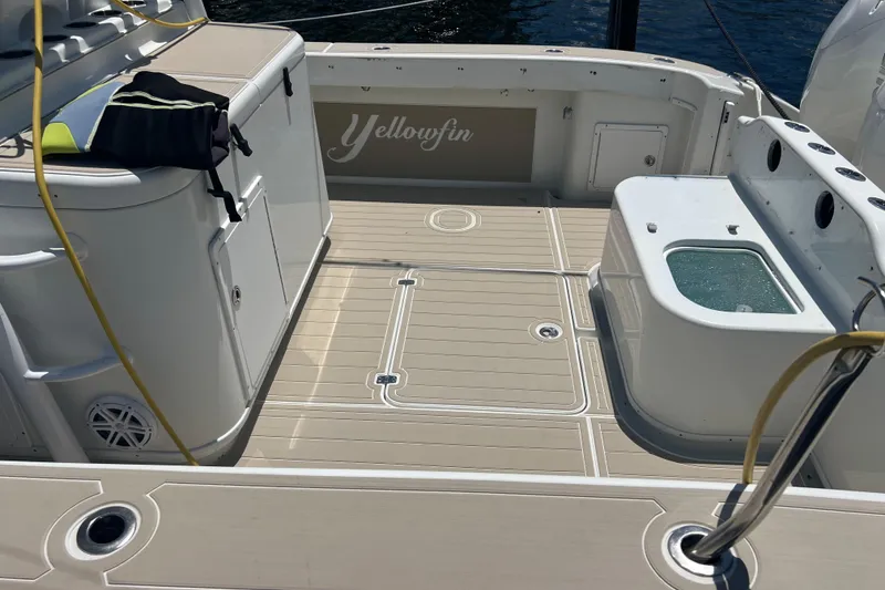 Slide: The Image of 2011 Yellowfin 42 Offshore boat deck with storage and fishing equipment. - 12