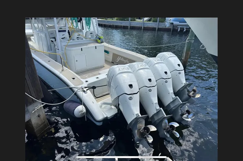 Slide: The Image of 2011 Yellowfin 42 Offshore boat with four powerful outboard engines docked at marina. - 8