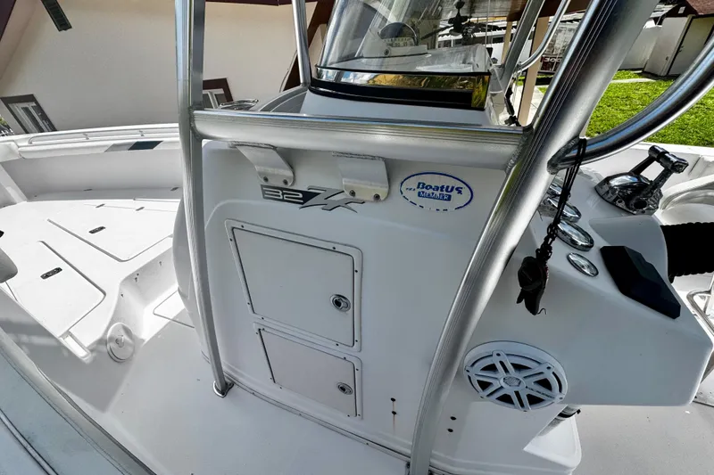 Slide: The Image of 2006 Donzi 32 ZF boat interior with control panel and storage compartments. - 12