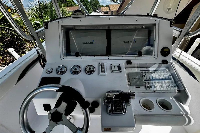 Slide: The Image of 2006 Donzi 32 ZF boat dashboard with Garmin navigation system and controls. - 13