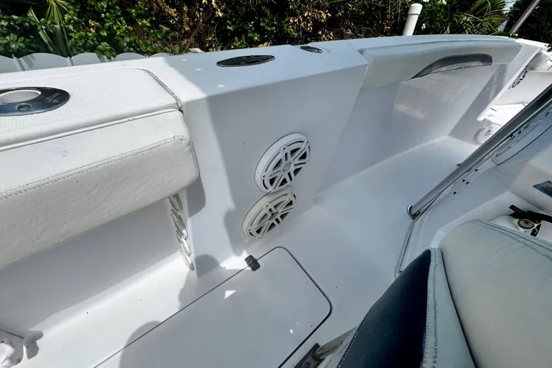 Slide: The Image of 2006 Donzi 32 ZF boat interior with white seating and speaker system. - 17