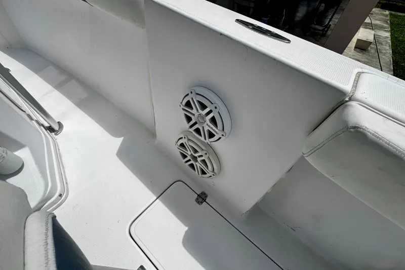 Slide: The Image of 2006 Donzi 32 ZF boat interior with dual speakers and white seating. - 18