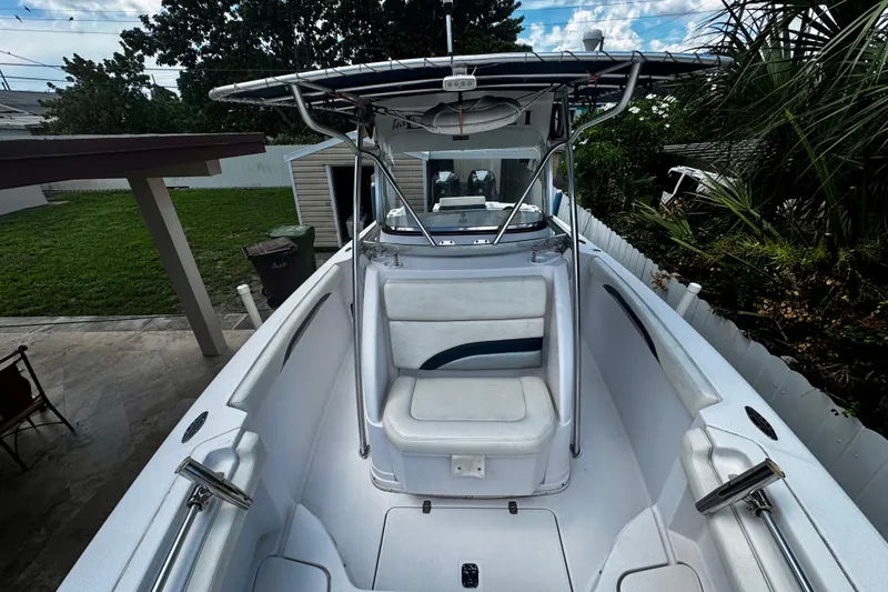 Slide: The Image of 2006 Donzi 32 ZF boat with seating, parked in a backyard setting. - 19