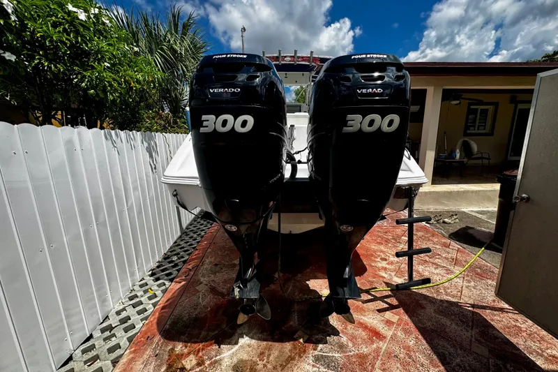 Slide: The Image of 2006 Donzi 32 ZF boat with twin 300 horsepower Verado engines in a sunny yard. - 2