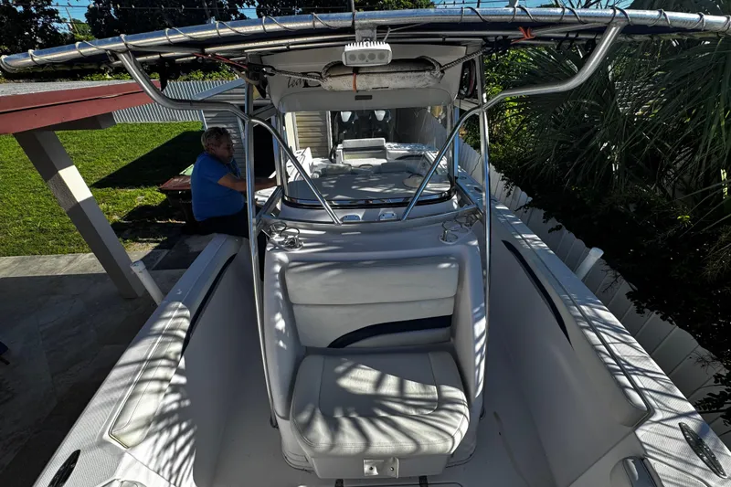 Slide: The Image of 2006 Donzi 32 ZF boat with T-top, parked near a garden area. - 20