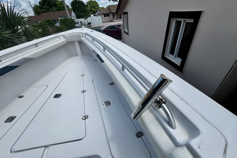 Slide: The Image of 2006 Donzi 32 ZF boat deck with stainless steel railings and storage compartments. - 22