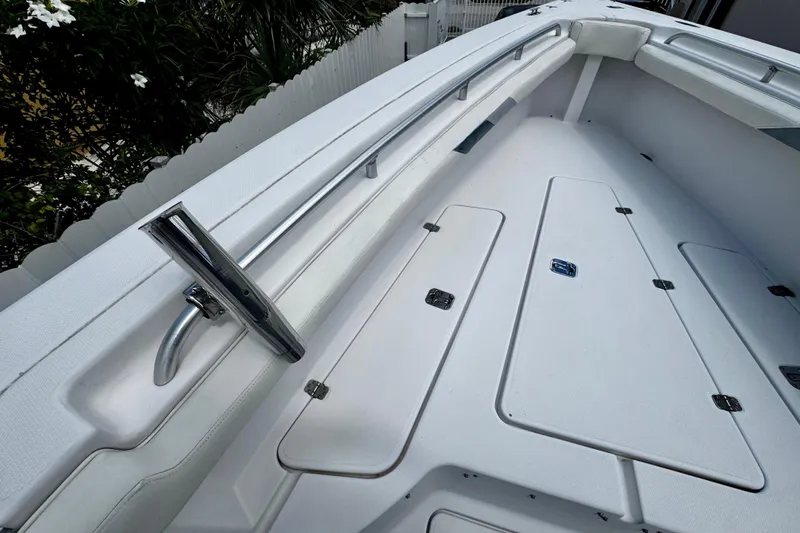 Slide: The Image of 2006 Donzi 32 ZF boat interior with white deck and storage compartments. - 23