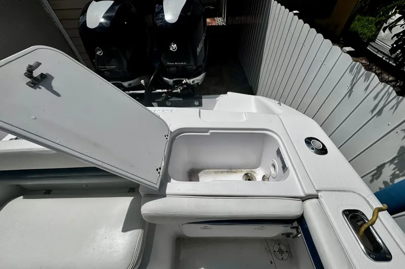 Slide: The Image of 2006 Donzi 32 ZF boat interior with open storage compartment and dual Mercury engines. - 7