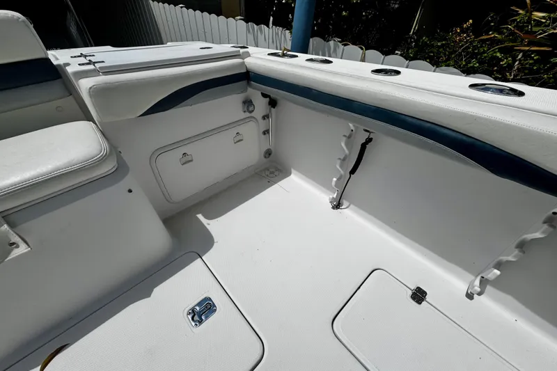 Slide: The Image of 2006 Donzi 32 ZF boat interior with white seating and storage compartments. - 9