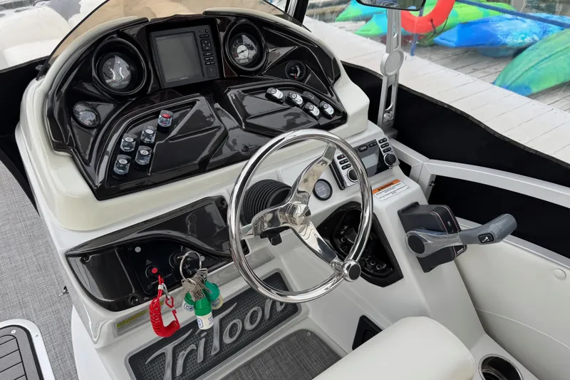 Slide: The Image of Control panel of 2017 JC SportToon 24TT boat with steering wheel and dashboard. - 10