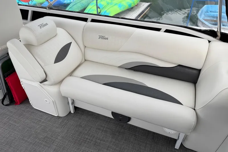 Slide: The Image of Luxurious seating on 2017 JC SportToon 24TT boat, featuring elegant white and gray upholstery. - 14