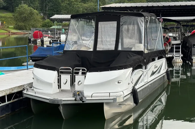 Slide: The Image of 2017 JC SportToon 24TT pontoon boat docked with protective cover. - 2