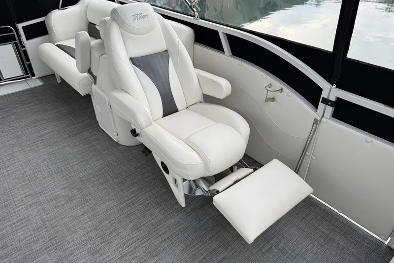 Slide: The Image of Luxurious seating on 2017 JC SportToon 24TT pontoon boat, featuring plush white upholstery. - 7