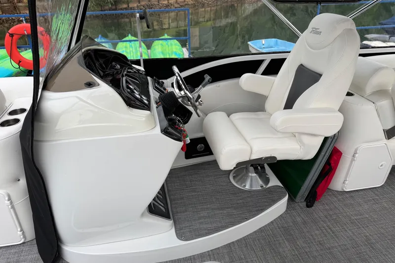 Slide: The Image of Captain's chair and helm of 2017 JC SportToon 24TT boat, featuring sleek design and controls. - 8