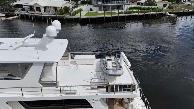 Slide: The Image of Aerial view of 2020 Hampton 658l Endurance yacht docked by waterfront homes. - 36