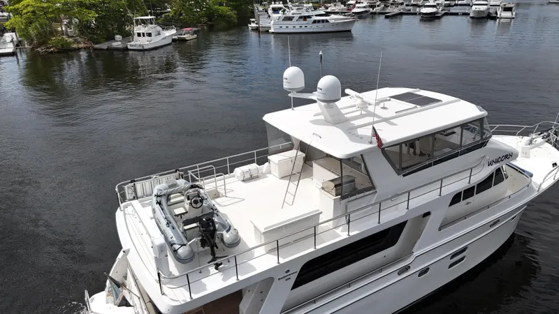 Slide: The Image of 2020 Hampton 658l Endurance yacht docked in a marina, surrounded by water and other boats. - 38