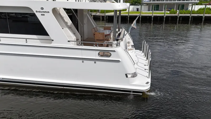 Slide: The Image of 2020 Hampton 658l Endurance yacht on calm water, rear view. - 41