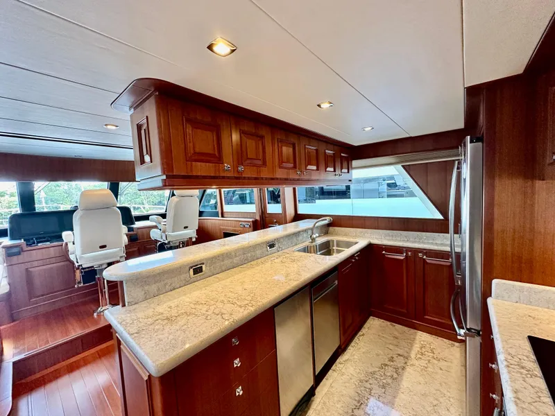 Slide: The Image of Luxurious kitchen interior of 2020 Hampton 658l Endurance yacht with wood cabinetry and marble countertops. - 72