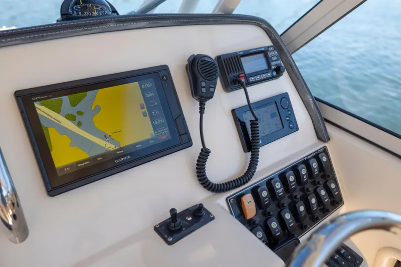 Slide: The Image of Control panel of 2017 Grady-White Freedom 235 boat with Garmin GPS and communication devices. - 20