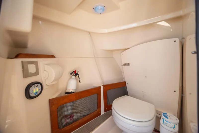 Slide: The Image of 2017 Grady-White Freedom 235 boat interior with toilet and safety equipment. - 25