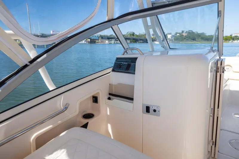 Slide: The Image of Interior view of 2017 Grady-White Freedom 235 boat, featuring helm and seating area. - 26