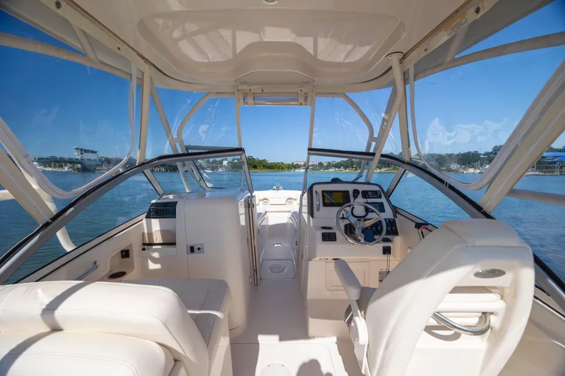 Slide: The Image of 2017 Grady-White Freedom 235 boat interior with helm, seats, and water view. - 28