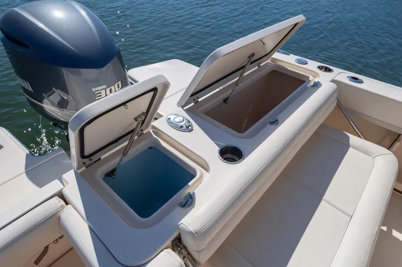 Slide: The Image of 2017 Grady-White Freedom 235 boat with open storage compartments and Yamaha 300 engine. - 34