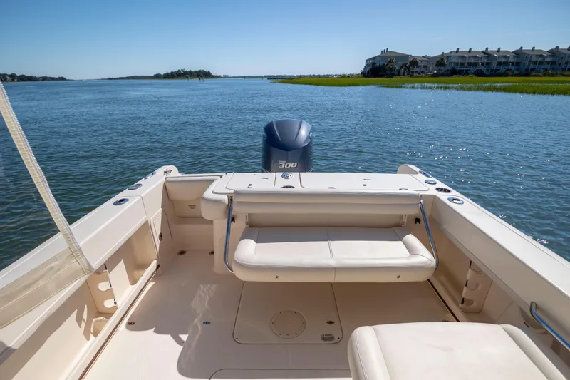 Slide: The Image of 2017 Grady-White Freedom 235 boat on calm water, featuring spacious seating and scenic views. - 36