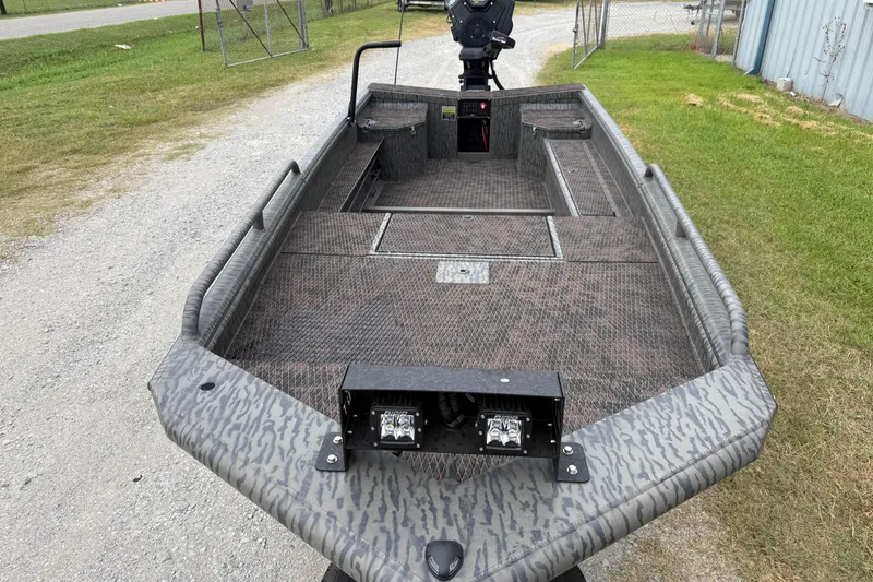 Slide: The Image of 2026 Gator Tail 1750 MID DECK SAVAGE boat with camo pattern, parked on gravel. - 4