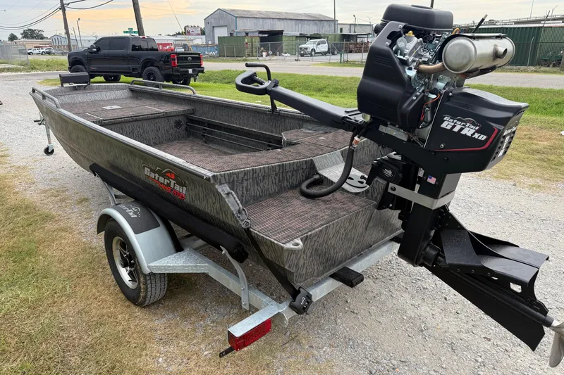 Slide: The Image of 2026 Gator Tail 1750 MID DECK SAVAGE boat on trailer, featuring powerful outboard motor. - 5