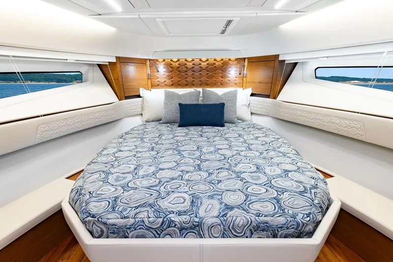 Slide: The Image of Manufacturer Provided Image: Luxurious 2025 Tiara Yachts 43 LE cabin interior with elegant bedding and modern design. - 13