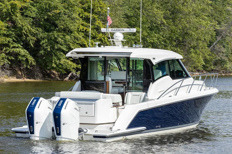 Slide: The Image of Manufacturer Provided Image: 2025 Tiara Yachts 43 LE on water, featuring dual outboard engines and sleek design. - 2