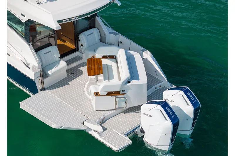 Slide: The Image of Manufacturer Provided Image: 2025 Tiara Yachts 43 LE with dual Mercury engines on turquoise water. - 5