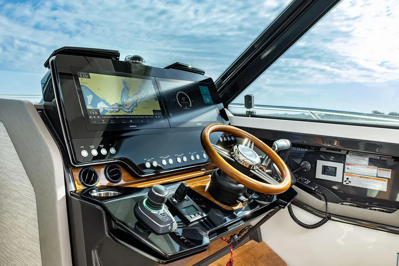 Slide: The Image of Manufacturer Provided Image: Helm of 2025 Tiara Yachts 43 LE with advanced navigation system and wooden steering wheel. - 8