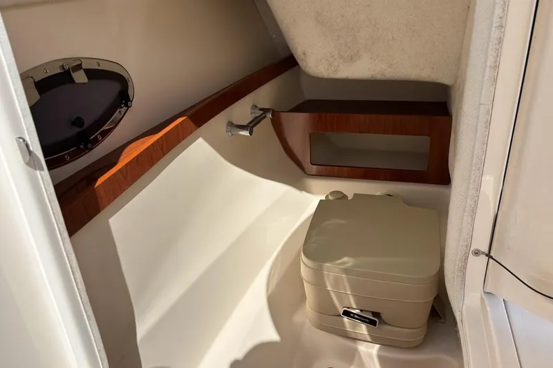 Slide: The Image of 2010 Regal 2700 ES Bowrider interior with white seating and dashboard details. - 12