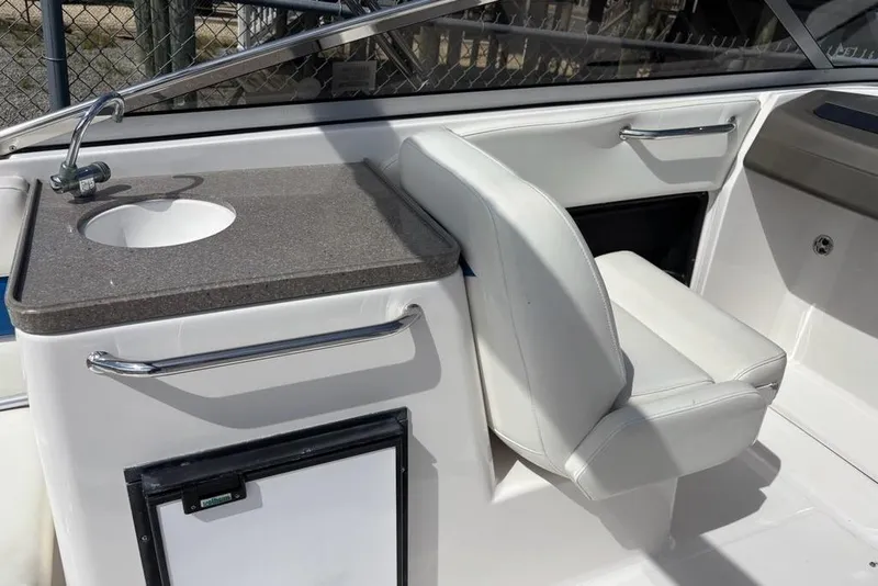Slide: The Image of 2010 Regal 2700 ES Bowrider interior with portable toilet and storage. - 13