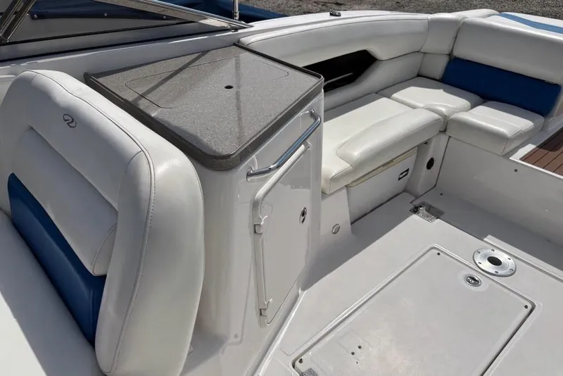 Slide: The Image of 2010 Regal 2700 ES Bowrider interior with white and blue seating, open layout. - 16