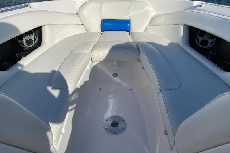 Slide: The Image of 2010 Regal 2700 ES Bowrider interior with white seating and cup holders. - 23