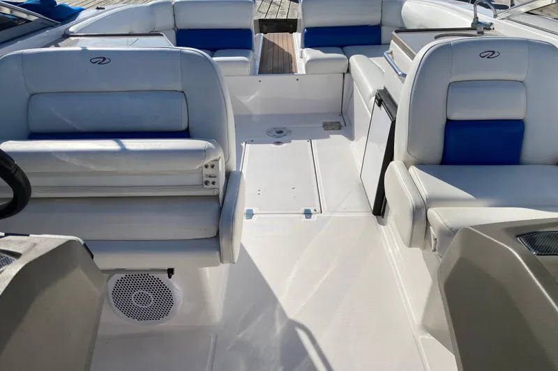 Slide: The Image of 2010 Regal 2700 ES Bowrider interior with white and blue seating, spacious layout. - 24
